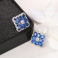 Huitan Silver Cubic Zirconia Stud Earrings – White & Blue CZ